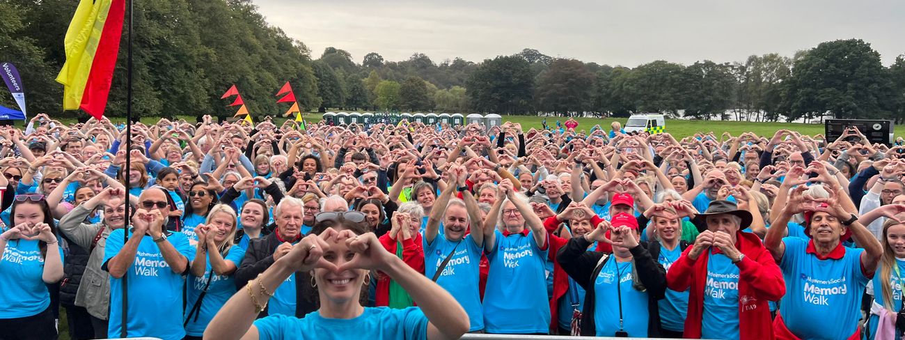Alzheimer's Society Memory Walk participants forming heart hands