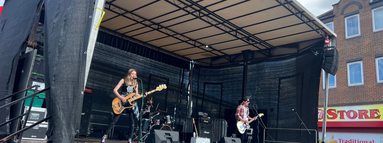 Band performing on a mobile trailer stage at an outdoor festival