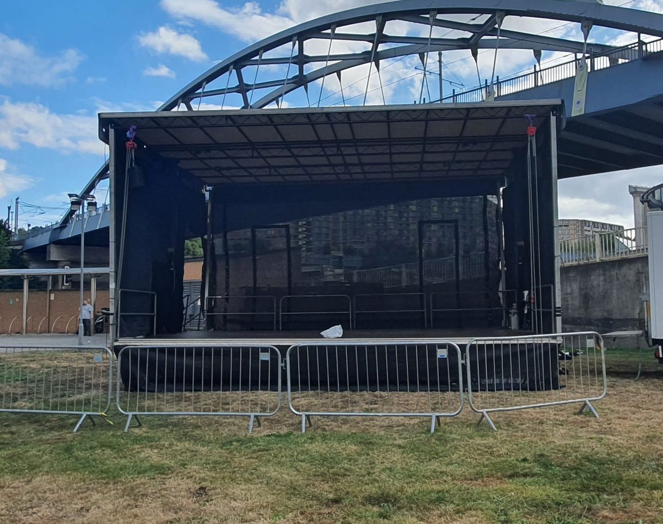 Mobile trailer stage with crowd barriers at an event